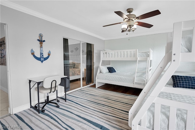 bedroom with ceiling fan, crown molding, a closet, and hardwood / wood-style floors