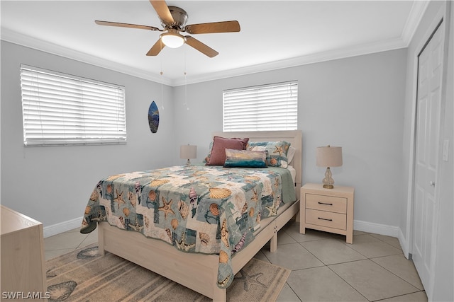 bedroom with a closet, ceiling fan, ornamental molding, and light tile patterned floors