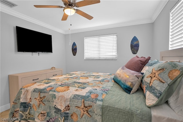 bedroom featuring multiple windows, ornamental molding, and ceiling fan