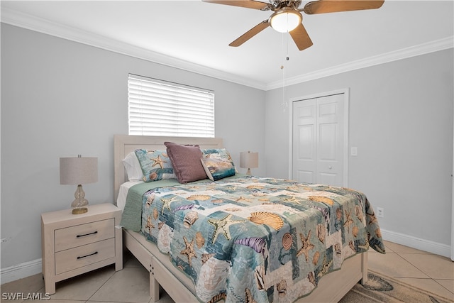 bedroom featuring ceiling fan, a closet, light tile patterned floors, and ornamental molding