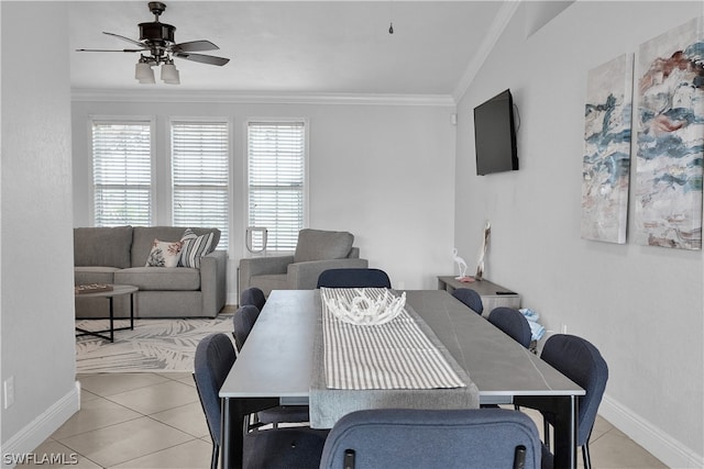 dining space featuring ornamental molding, lofted ceiling, ceiling fan, and tile patterned flooring