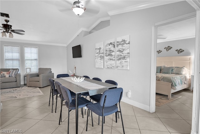 tiled dining space with ceiling fan, lofted ceiling, and ornamental molding