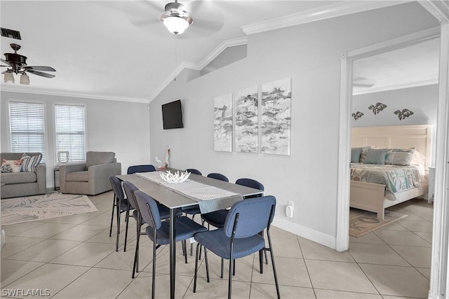 dining space with lofted ceiling, light tile patterned floors, and crown molding