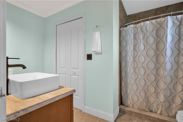 bathroom featuring ornamental molding, vanity, and tile patterned flooring