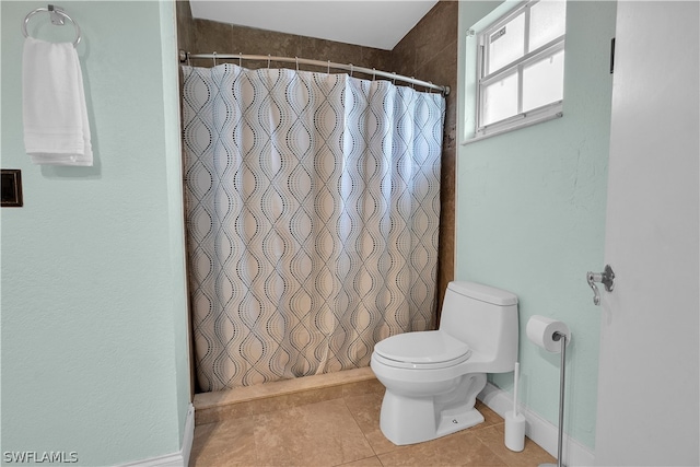 bathroom with tile patterned floors and toilet