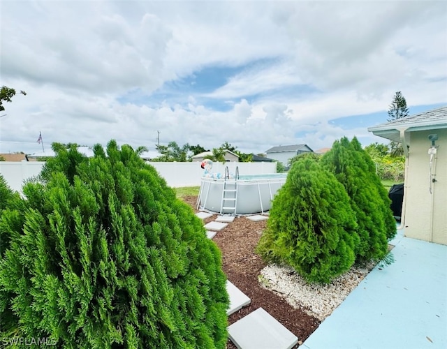 view of yard with a fenced in pool