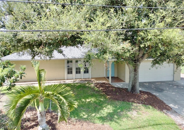 view of front of property with a garage and french doors