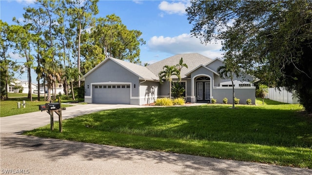 view of front of property with a garage and a front lawn