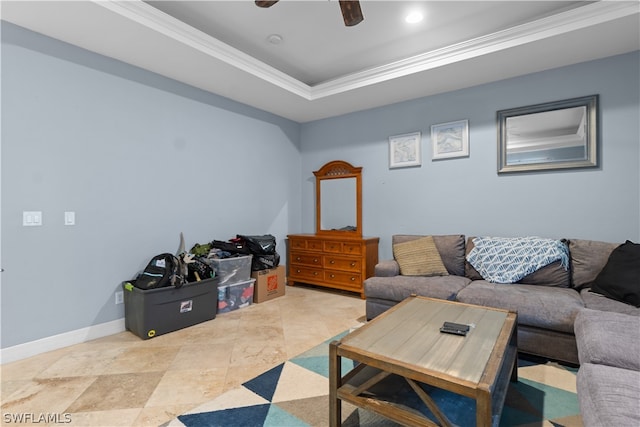 tiled living room with ceiling fan, a raised ceiling, and crown molding