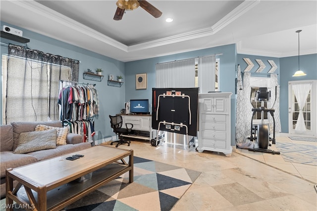 living room with tile patterned floors, ceiling fan, a raised ceiling, and crown molding