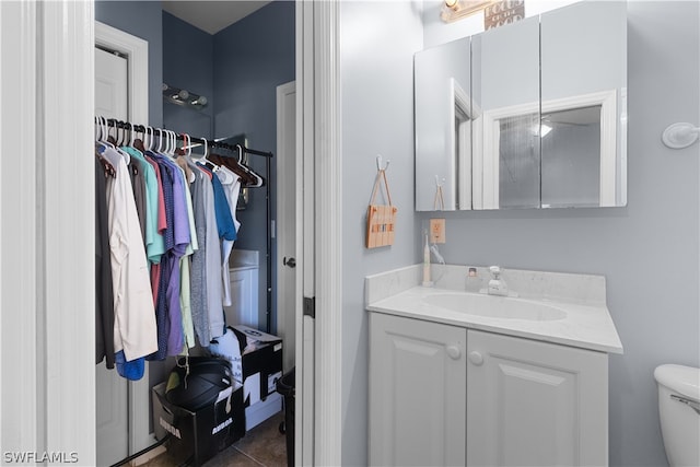 bathroom with tile patterned floors, toilet, and vanity