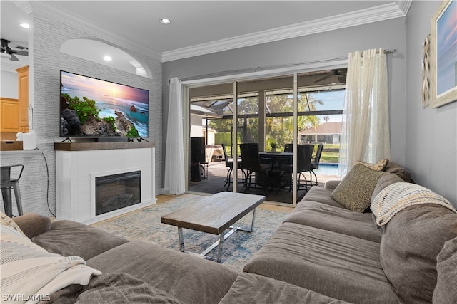 living room featuring ornamental molding and ceiling fan