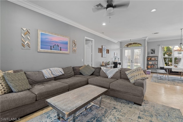 living room featuring tile patterned flooring, ceiling fan with notable chandelier, crown molding, and french doors