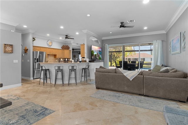 tiled living room featuring crown molding and ceiling fan