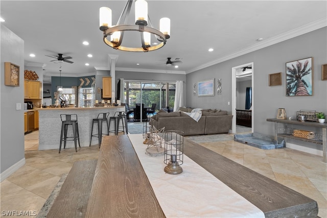 dining area with ornamental molding, ceiling fan with notable chandelier, and light tile patterned floors