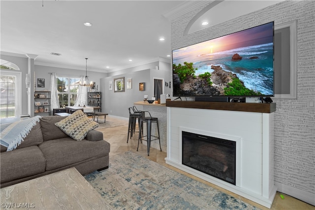 living room featuring ornamental molding and an inviting chandelier