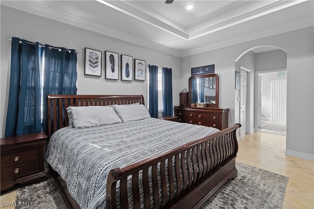 tiled bedroom with ornamental molding and connected bathroom