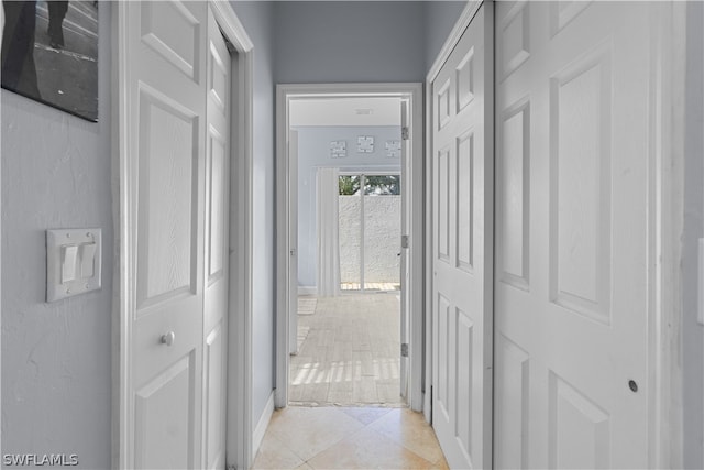 hallway with light tile patterned floors