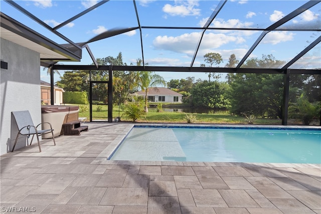 view of swimming pool featuring a patio and glass enclosure