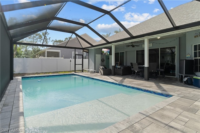 view of swimming pool with a lanai, a patio, and ceiling fan