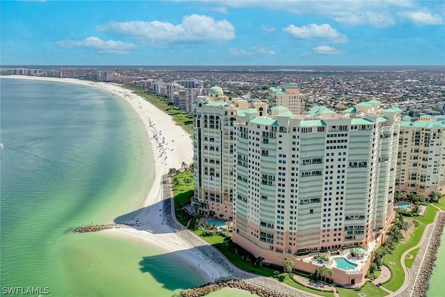 bird's eye view with a water view and a beach view