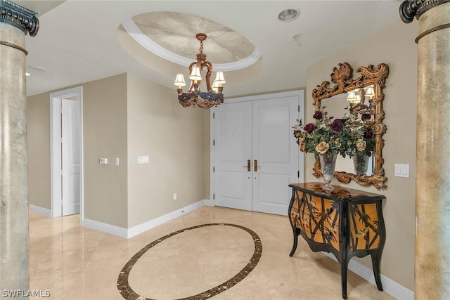 foyer featuring a raised ceiling and a chandelier