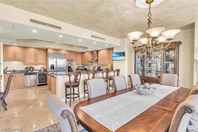 dining space featuring an inviting chandelier and beverage cooler