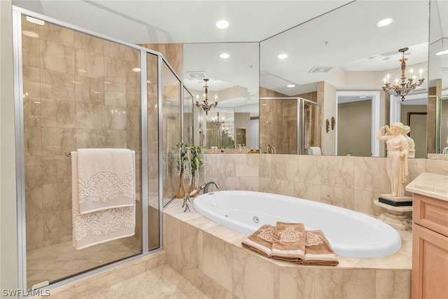 bathroom with vanity, shower with separate bathtub, and a notable chandelier