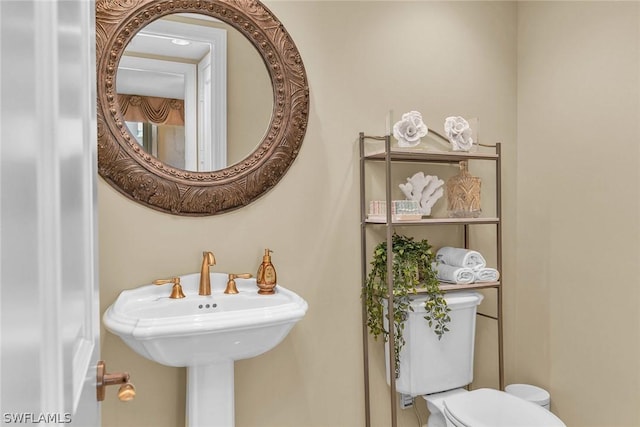 bathroom with toilet and sink