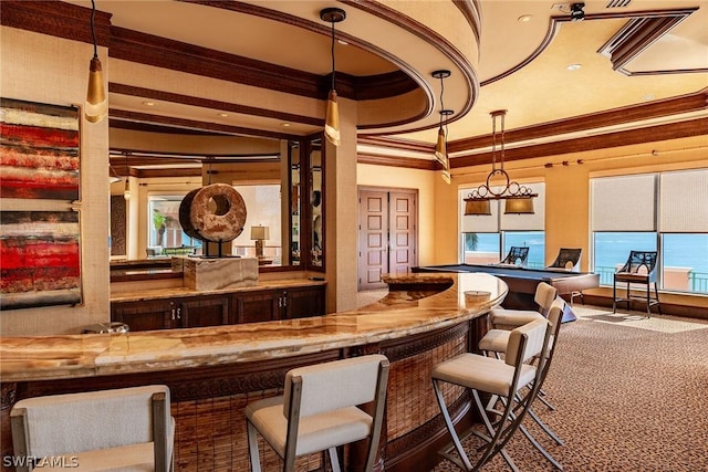 bar with pendant lighting, ornamental molding, and carpet flooring