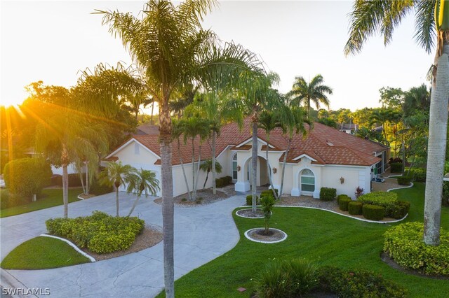 mediterranean / spanish-style home featuring a front yard