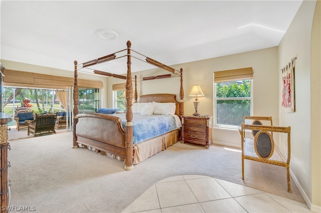 carpeted bedroom with access to outside, baseboards, and tile patterned floors