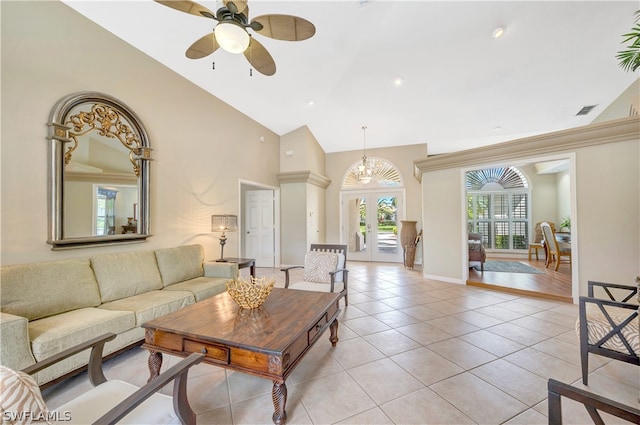 living area featuring high vaulted ceiling, light tile patterned flooring, visible vents, a ceiling fan, and french doors