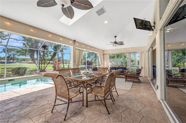 sunroom / solarium with a ceiling fan, a skylight, and visible vents