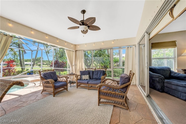 sunroom / solarium featuring a wealth of natural light and a ceiling fan