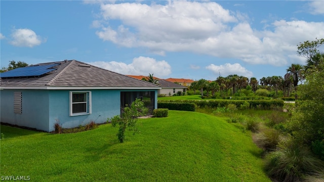 exterior space featuring a yard and solar panels