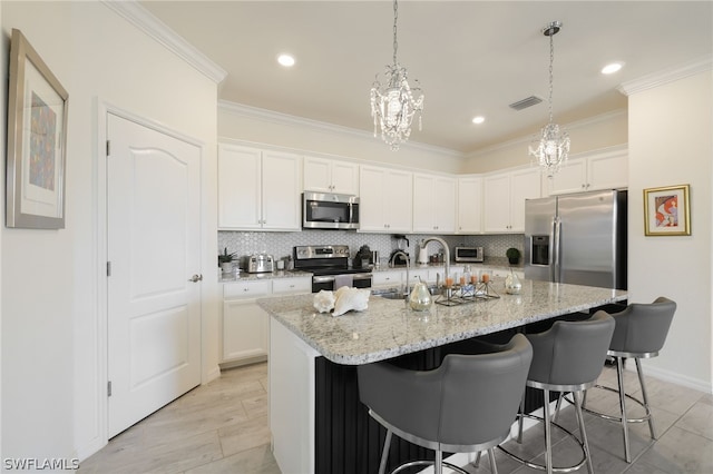 kitchen with sink, white cabinetry, light stone counters, a kitchen island with sink, and appliances with stainless steel finishes