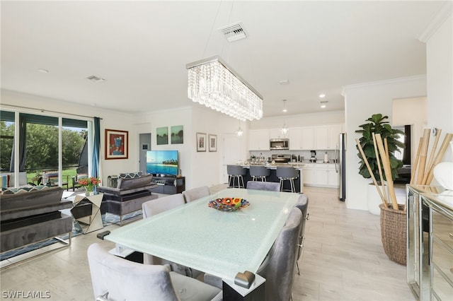 dining room featuring crown molding and a notable chandelier