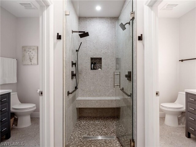 bathroom with toilet, walk in shower, and vanity