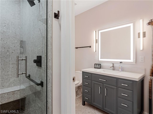 bathroom featuring a shower with door, tile patterned floors, vanity, and toilet