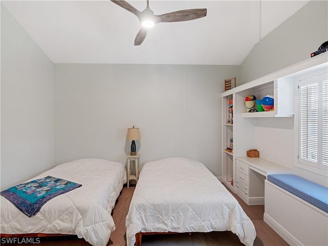 bedroom with vaulted ceiling, ceiling fan, wood-type flooring, and multiple windows