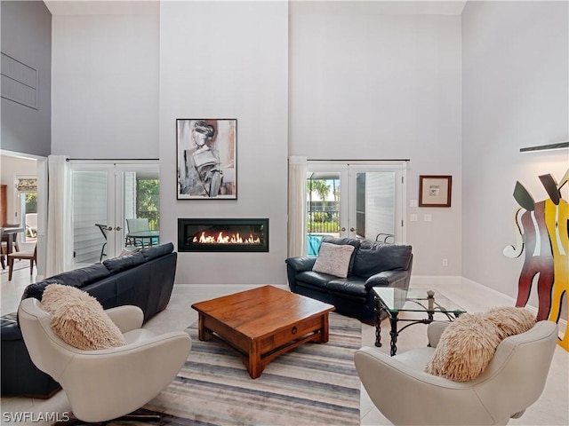 living room with a high ceiling and french doors