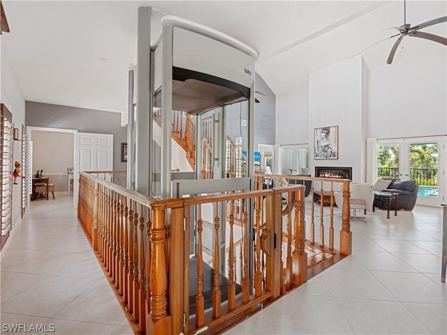 corridor with high vaulted ceiling and light tile patterned floors