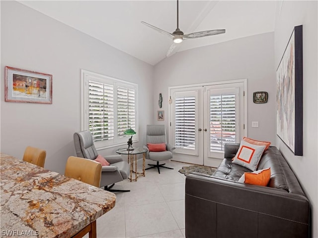 tiled living room with ceiling fan and vaulted ceiling