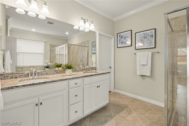 bathroom featuring tile patterned floors, vanity, crown molding, and walk in shower