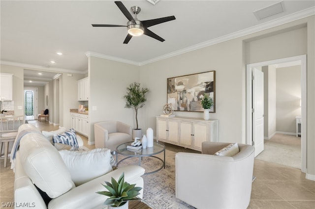 tiled living room featuring ceiling fan and ornamental molding