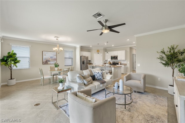 tiled living room with ceiling fan with notable chandelier and crown molding