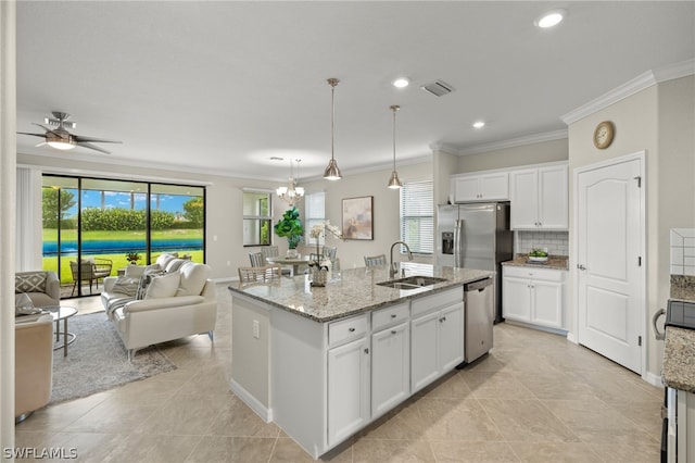 kitchen with a center island with sink, ceiling fan with notable chandelier, white cabinetry, and sink