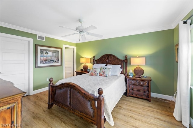 bedroom with ceiling fan, crown molding, and light hardwood / wood-style flooring