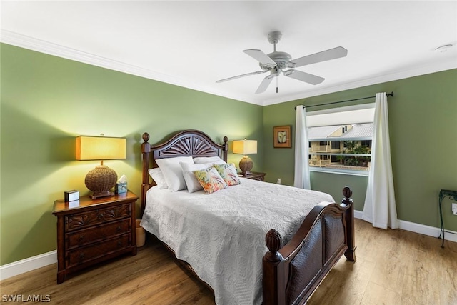 bedroom with ceiling fan, hardwood / wood-style floors, and crown molding